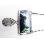 AN ARTS AND CRAFT STYLE ENAMELLED PENDANT. THE CENTRAL RECTANGLE ENAMEL IS A MOUNTAIN LANDSCAPE