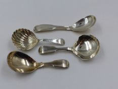 THREE SILVER HALLMARKED AND ONE WHITE METAL CADDY SPOON OF VARIOUS DATES AND STYLES TO INCLUDE A