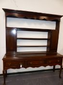 AN 18th.C.OAK DRESSER WITH RAISED SHELF BACK OVER THREE DRAWERS AND STANDING ON CABRIOLE LEGS. W.