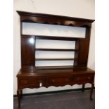 AN 18th.C.OAK DRESSER WITH RAISED SHELF BACK OVER THREE DRAWERS AND STANDING ON CABRIOLE LEGS. W.