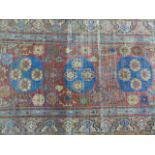 AN ANTIQUE KHOTAN RUG 294 X 154 CM