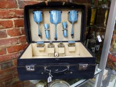 A SILVER HALLMARKED VANITY TRAVEL SET IN POWDER BLUE WITH AN ART DECO GUILLOCHE ENAMEL DESIGN IN A