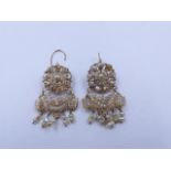 A PAIR OF PRECIOUS YELLOW METAL ORNATE BAROQUE PEARL CHANDELIER EARRINGS ON A HINGED WIRE