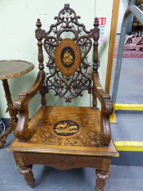 A 19th.C.SWISS BLACK FOREST CARVED AND INLAID ARMCHAIR WITH UNUSUAL SPRUNG SEAT AND INTEGRAL