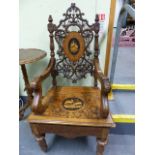 A 19th.C.SWISS BLACK FOREST CARVED AND INLAID ARMCHAIR WITH UNUSUAL SPRUNG SEAT AND INTEGRAL