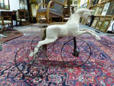 A RARE EARLY 20th.C.VELOCIPEDE HORSE FORM TRICYCLE.