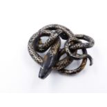 A PIQUE WORK COILED SERPENT BROOCH. APPROXIMATE MEASUREMENT 5.5cms.