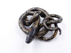 A PIQUE WORK COILED SERPENT BROOCH. APPROXIMATE MEASUREMENT 5.5cms.