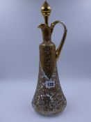 A LATE 19th.C. FRENCH GLASS DECANTER AND STOPPER EMBELLISHED WITH GILDING. 39cms. HIGH.