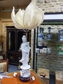 A CHINESE BLANC DE CHINE STANDING FIGURE OF A DEITY FITTED AS A LAMP WITH PETAL FORM SILK SHADE. H.