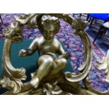 A LARGE AND ELABORATE CARVED GILT BRACKETED WALL MIRROR SURMOUNTED WITH CHERUBS. H.147cms.
