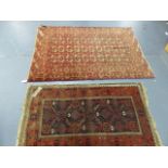 AN ANTIQUE BELOUCH RUG. 155 x 94cms. TOGETHER WITH AN ANTIQUE TEKKE BOKHARA RUG. 190 x 138cms. (2)