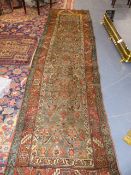 AN ANTIQUE PERSIAN HERIZ RUNNER. 385 x 106cms.