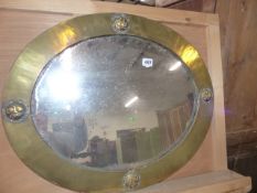 AN ARTS AND CRAFTS BRASS FRAMED MIRROR LABELLED LIBERTY, LONDON.