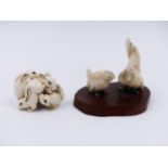 A JAPANESE CARVED IVORY FIGURE OF FOUR PLAYFUL RABBITS (H.3cms.) TOGETHER WITH A GROUP OF TWO