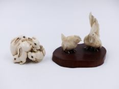 A JAPANESE CARVED IVORY FIGURE OF FOUR PLAYFUL RABBITS (H.3cms.) TOGETHER WITH A GROUP OF TWO