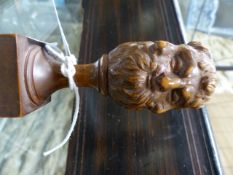 A FINELY CARVED TREEN ORNAMENT WITH GROTESQUE MASK KNOP FINIAL. H.9cms.