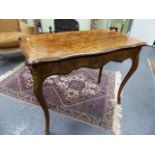 A 19th.C.WALNUT FOLD OVER CARD TABLE OF SERPENTINE OUTLINE WITH GILT BRASS MOUNTED CABRIOLE LEGS.