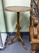 AN INTERESTING BLACK FOREST OR GROTTO TYPE TRIPOD TABLE WITH CARVED BASE AND LEAF DECORATION TO TOP.