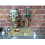 AN UNUSUAL STEAM PUNK THEMED DESK LAMP WITH CARVED BASE AND ILLUMINATING SKULL.