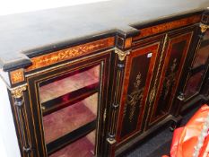 A VICTORIAN AESTHETIC EBONISED AND INLAID LOW BOOKCASE WITH TWO GLAZED AND TWO PANEL DOORS. W.184