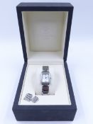 A CHRISTOPHER WARD LONDON LADIES DIAMOND SET QUARTZ WATCH ON A STAINLESS STEEL BRACELET WITH BI-