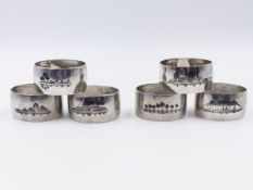 SIX IRAQU NIELLO SERVIETTE RINGS EACH ONE HAVING A DIFFERENT SCENE ON BOTH SIDES.