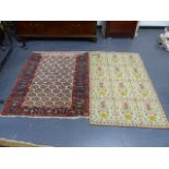 AN ANTIQUE PERSIAN RUG. 128 x 106cms. TOGETHER WITH A CONTINENTAL NEEDLEWORK RUG. 141 x 91cms. (2)