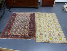 AN ANTIQUE PERSIAN RUG. 128 x 106cms. TOGETHER WITH A CONTINENTAL NEEDLEWORK RUG. 141 x 91cms. (2)