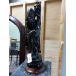 A CHINESE CARVED FIGURE OF A STANDING SAGE WITH WIREWORK INLAY MOUNTED AS A LAMP. H.OVERALL 63cms.