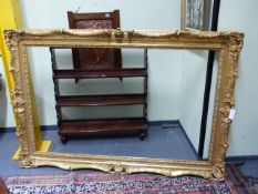 A LARGE GILT SWEPT ROCOCO STYLE PICTURE/MIRROR FRAME, REBATE 93 x 146cms.