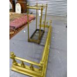 A LATE VICTORIAN BRASS AND IRON STICKSTAND TOGETHER WITH A SIMILAR PERIOD BRASS FENDER. W.140cms.