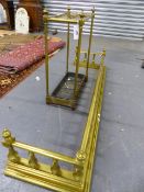 A LATE VICTORIAN BRASS AND IRON STICKSTAND TOGETHER WITH A SIMILAR PERIOD BRASS FENDER. W.140cms.