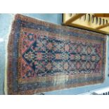 A GROUP OF FIVE ANTIQUE PERSIAN RUGS TO INCLUDE AFSHAR, HAMADAN AND BELOUCH EXAMPLES.