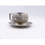 A CHINESE EXPORT SILVER DRAGON DECORATED CUP AND SAUCER WITH IMPRESSED CHARACTER MARKS.