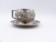 A CHINESE EXPORT SILVER DRAGON DECORATED CUP AND SAUCER WITH IMPRESSED CHARACTER MARKS.