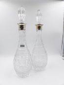 A PAIR OF SILVER MOUNTED CUT GLASS DECANTERS, DATED 1982 LONDON, MAKERS MARK C.J VANDEUS.