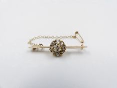 A PRECIOUS YELLOW METAL OLD CUT DIAMOND CLUSTER BAR BROOCH COMPLETE WITH A SAFETY CHAIN.