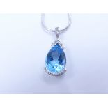 A PEAR SHAPE LARGE BLUE TOPAZ AND SILVER PENDANT.