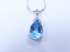 A PEAR SHAPE LARGE BLUE TOPAZ AND SILVER PENDANT.