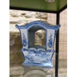 A CONTINENTAL DELFT BLUE AND WHITE POTTERY MODEL OF A SEDAN CHAIR. H.26cms x W.25cms.