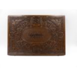 AN EASTERN CARVED SHALLOW DOCUMENT BOX, THE TOP DECORATED WITH STYLISED CALLIGRAPHY. W.36cms.