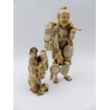 TWO JAPANESE CARVED IVORY FIGURES, A STANDING FIGURE OF A STREET VENDOR (H.15.5cms) AND A SMALLER