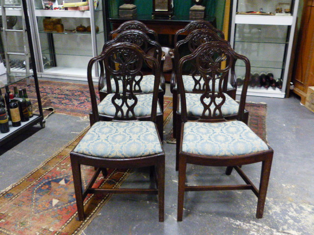 A SET OF SIX ANTIQUE GEO.III.STYLE MAHOGANY ARMCHAIRS WITH CURVED SEATS AND CARVED PIERCED BACKS.