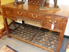 WITHDRAWN FROM SALE.....AN ORIENTAL HARDWOOD SIDE TABLE WITH FOUR DRAWERS, PIERCED FRIEZE AND