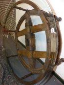 AN INTERESTING HAND MADE LARGE GLASS TOPPED COFFEE TABLE INCORPORATING AN EARLY WAGON WHEEL. D.