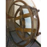 AN INTERESTING HAND MADE LARGE GLASS TOPPED COFFEE TABLE INCORPORATING AN EARLY WAGON WHEEL. D.