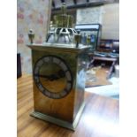 AN ANTIQUE BRASS CASED DESK CLOCK WITH PIERCED AND ENGRAVED DECORATION IN THE MANNER OF THE GUILD OF