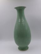 A CHINESE CELADON TAPERED BALUSTER FORM VASE WITH INCISED FLORAL DECORATION AND SEAL MARK TO BASE.