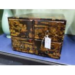 A CHINOISERIE DECORATED SMALL FOUR DRAWER FILR CHEST.
